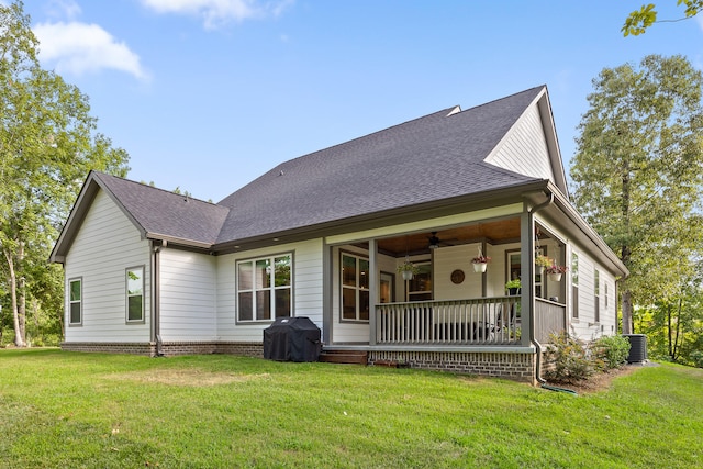 rear view of house featuring a yard, ceiling fan, and central air condition unit