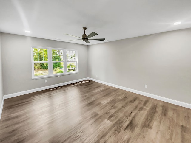 unfurnished room with ceiling fan and dark hardwood / wood-style floors