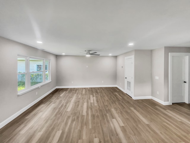 spare room featuring wood-type flooring and ceiling fan