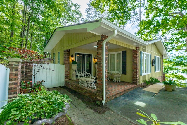 back of property with covered porch