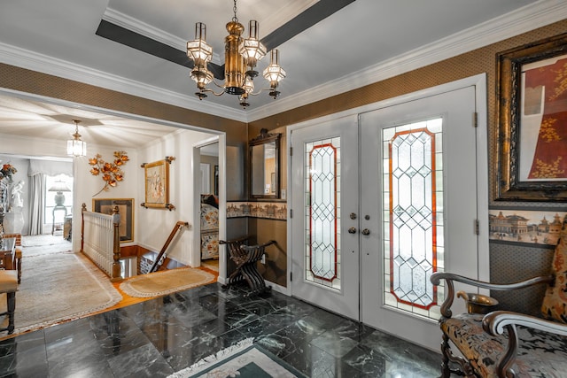 entryway featuring a chandelier, crown molding, marble finish floor, a tray ceiling, and french doors