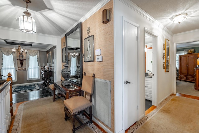 hallway featuring a textured ceiling, visible vents, baseboards, ornamental molding, and a notable chandelier