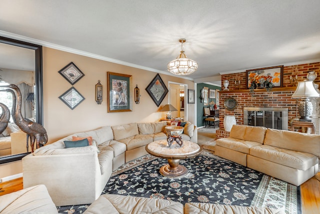 living room featuring a textured ceiling, ornamental molding, wood-type flooring, and a brick fireplace