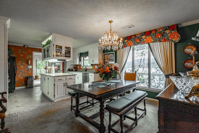 dining room with a wealth of natural light, a chandelier, and a textured ceiling