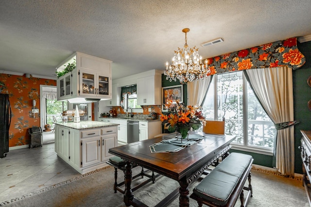 dining area featuring visible vents, wallpapered walls, a chandelier, and plenty of natural light