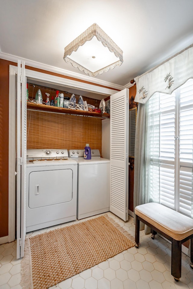 clothes washing area with independent washer and dryer and laundry area