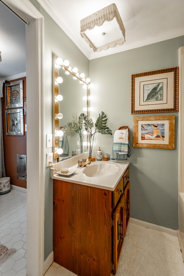 bathroom with tile patterned floors, ornamental molding, and vanity