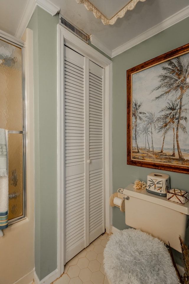 bedroom featuring ornamental molding and a closet