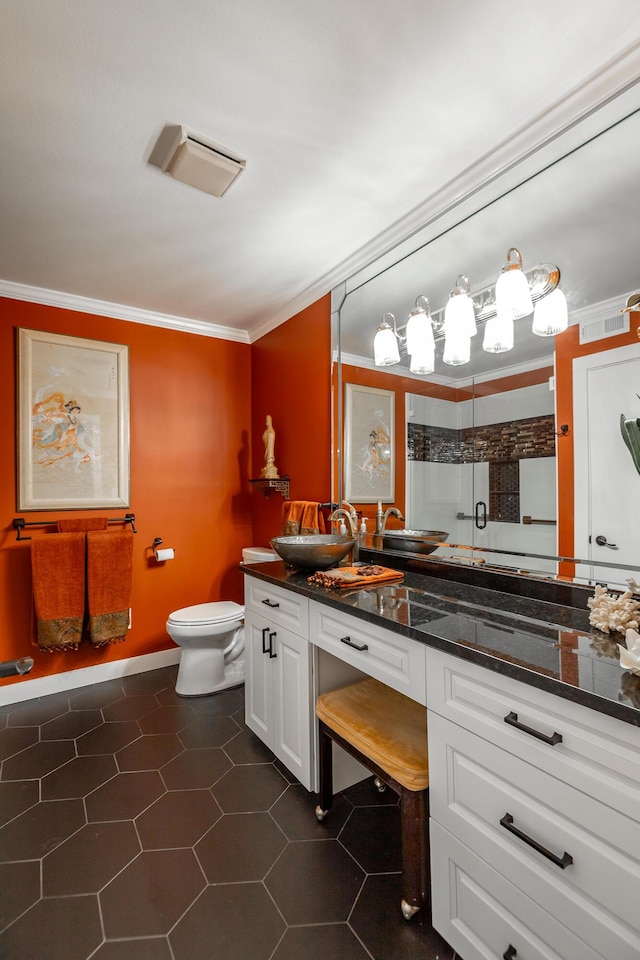 bathroom with a stall shower, tile patterned floors, toilet, a sink, and ornamental molding