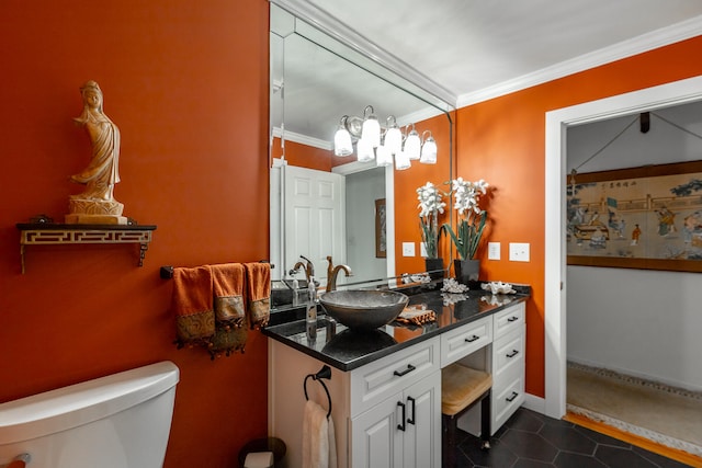 bathroom with toilet, crown molding, and vanity