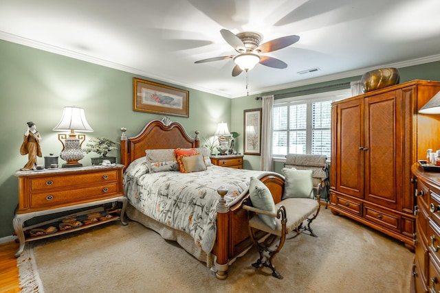 bedroom featuring ornamental molding, visible vents, ceiling fan, and light carpet