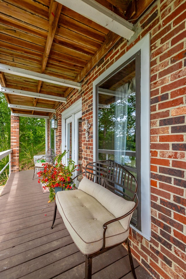 wooden terrace featuring covered porch