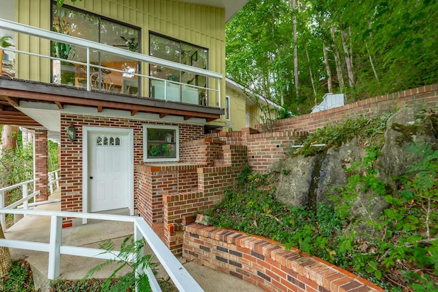 property entrance featuring brick siding