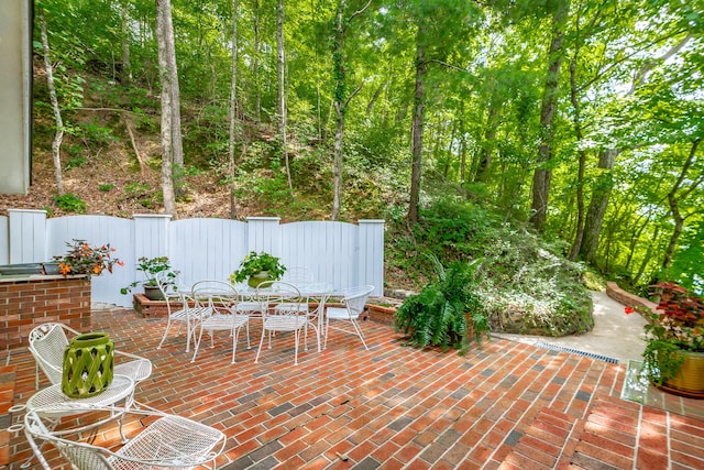 view of patio featuring fence and outdoor dining space