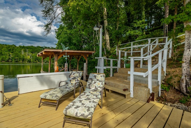 wooden deck featuring a water view and a wooded view