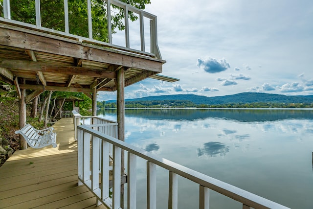 view of dock with a water and mountain view