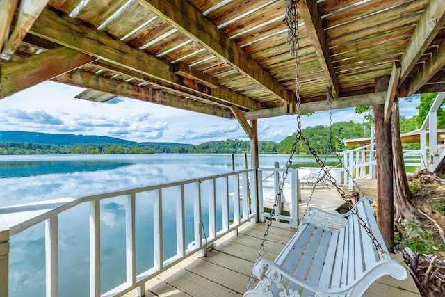 exterior space featuring a forest view and a water view