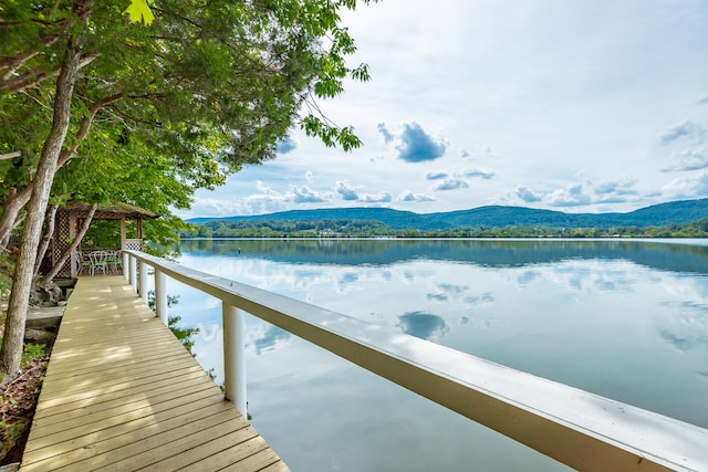 dock area with a water and mountain view and a gazebo