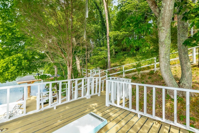 wooden deck featuring a water view