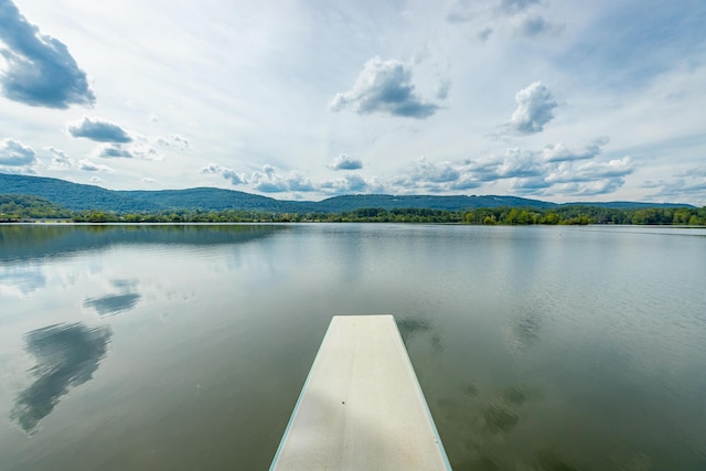 view of dock with a water and mountain view