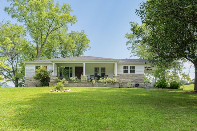 view of front of home with central air condition unit, covered porch, and a front lawn