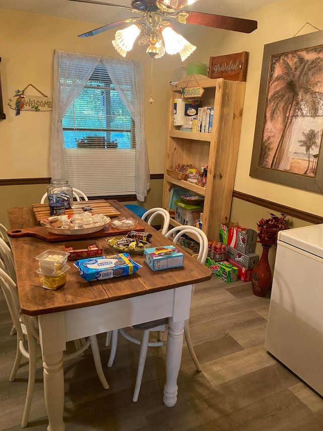 dining area with hardwood / wood-style floors and ceiling fan