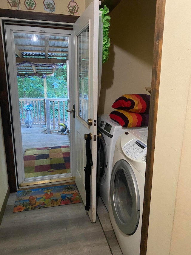 laundry area with hardwood / wood-style floors and washer and clothes dryer