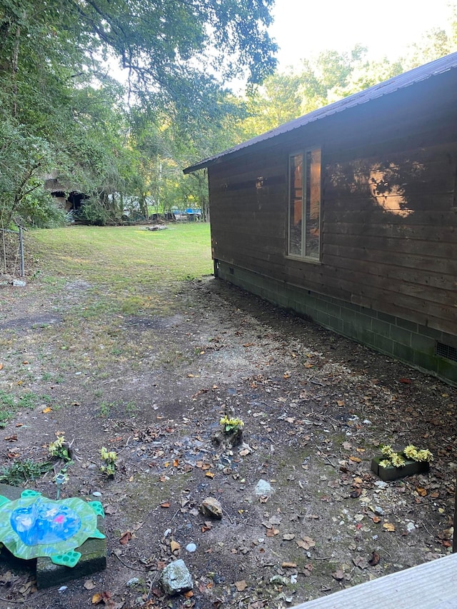 view of side of home featuring a yard