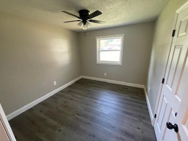 unfurnished bedroom featuring a textured ceiling, dark wood-type flooring, and ceiling fan