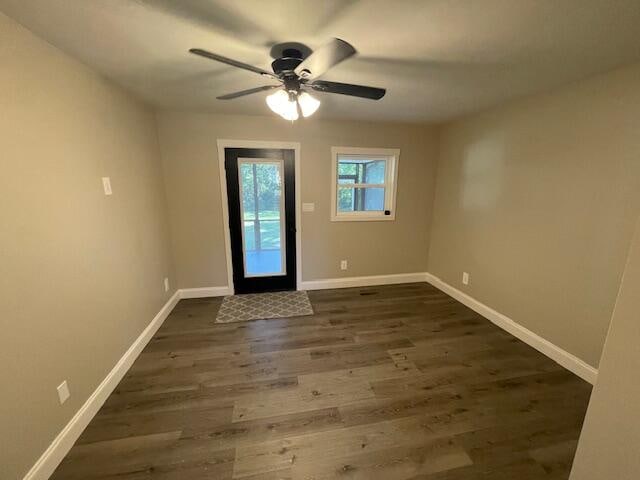 interior space featuring ceiling fan and dark hardwood / wood-style flooring