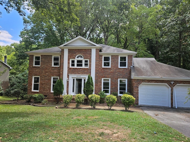 view of front of home featuring a garage and a front lawn