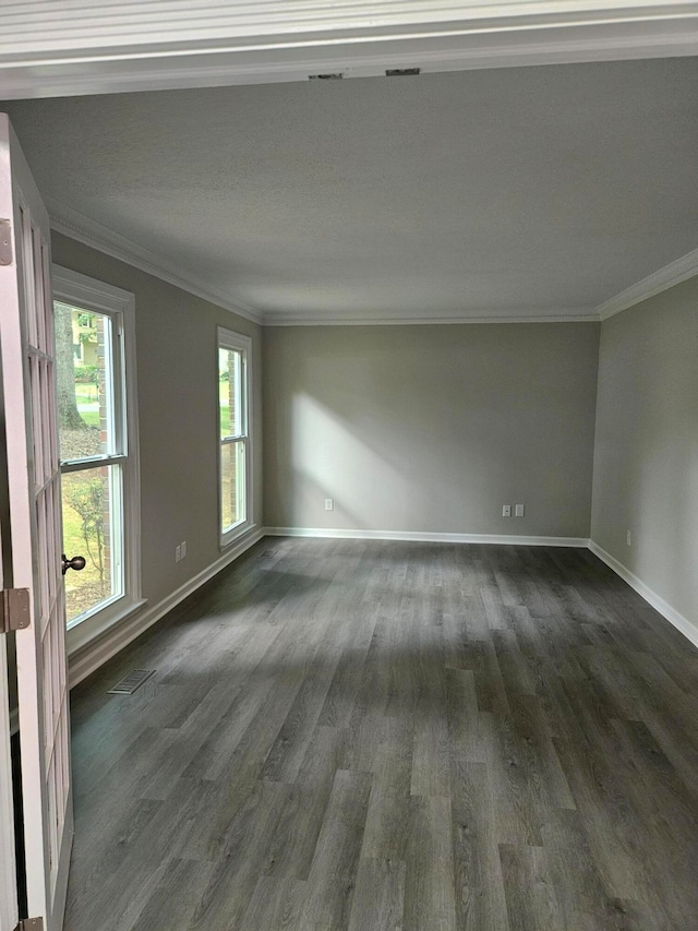 empty room featuring crown molding and dark wood-type flooring