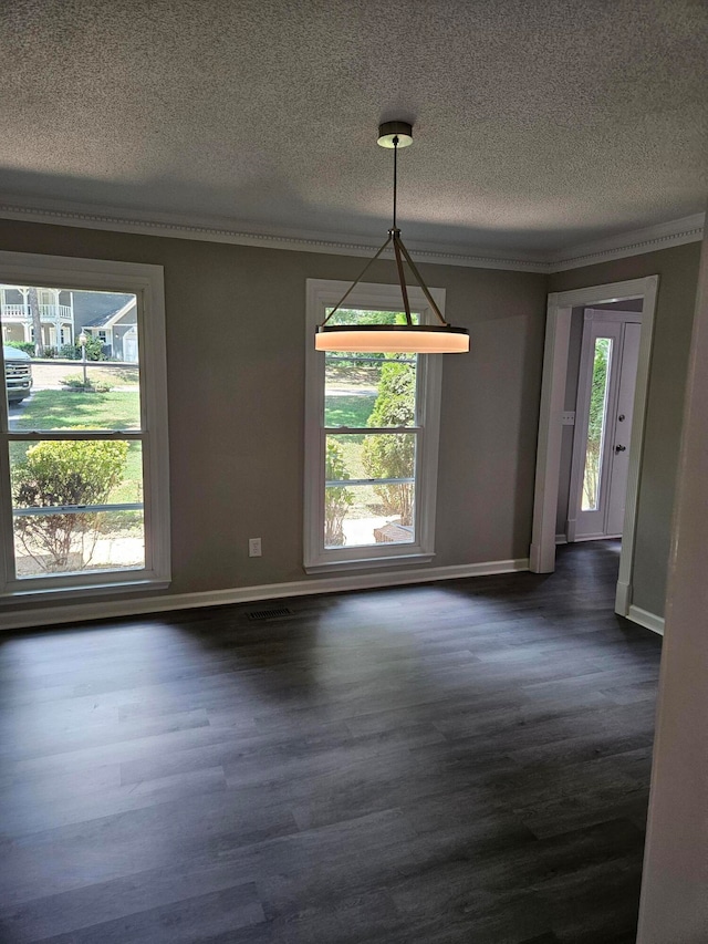 unfurnished dining area with a textured ceiling and dark wood-type flooring