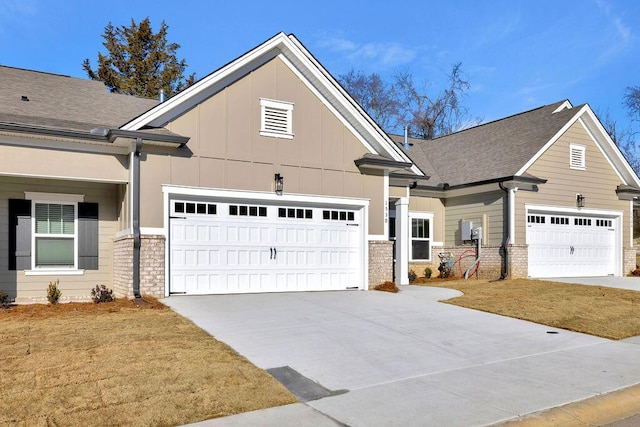 craftsman-style home featuring a garage and a front yard