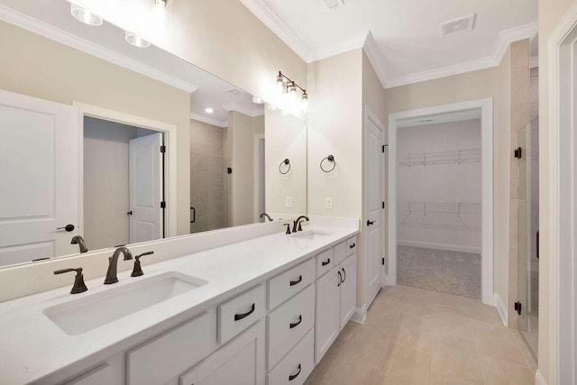 bathroom featuring a shower with door, ornamental molding, tile patterned flooring, and vanity