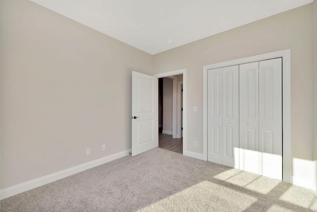 unfurnished bedroom featuring carpet floors and a closet