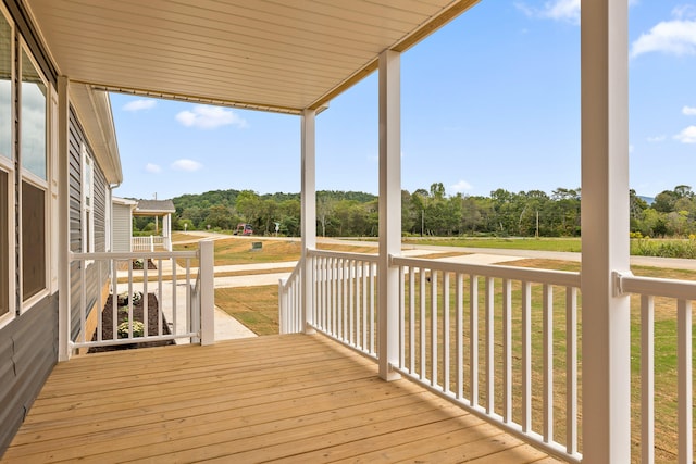 wooden deck with a lawn