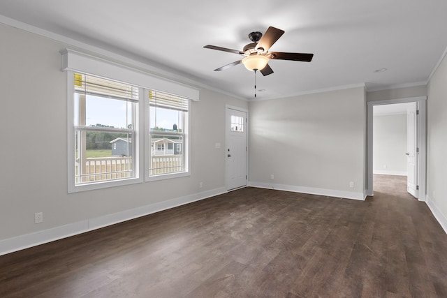 empty room with dark hardwood / wood-style floors, ornamental molding, and ceiling fan