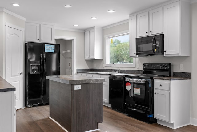 kitchen with black appliances, a center island, dark hardwood / wood-style floors, white cabinets, and sink