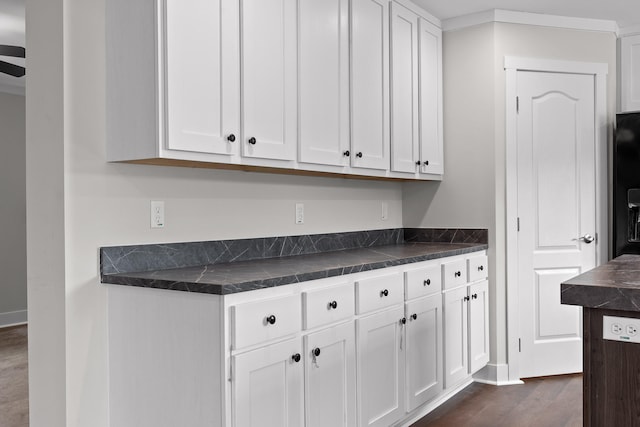 kitchen with white cabinets, dark hardwood / wood-style flooring, and ceiling fan