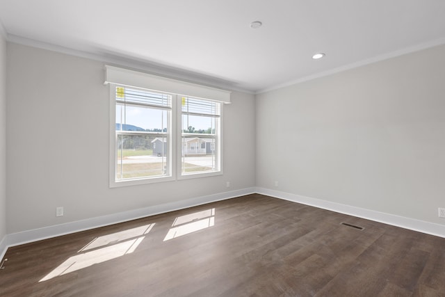 unfurnished room featuring crown molding and dark hardwood / wood-style flooring