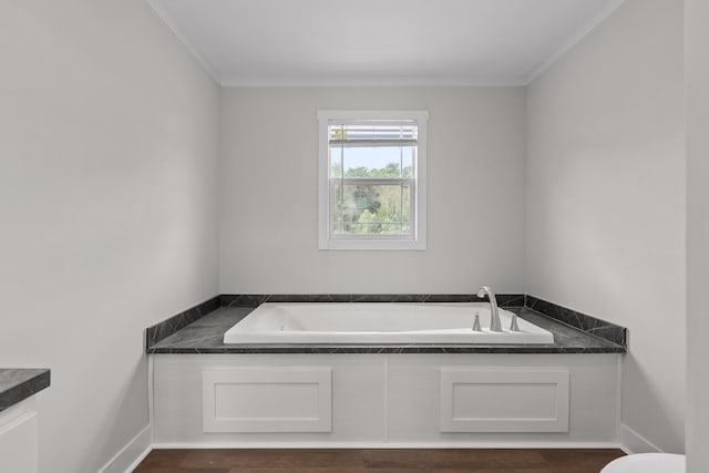 bathroom with wood-type flooring, crown molding, a tub to relax in, and vanity