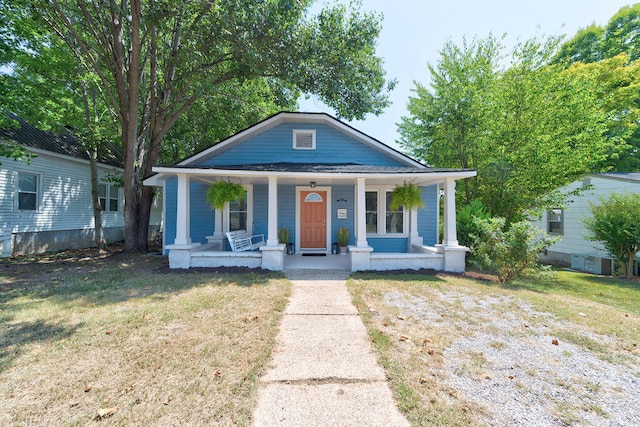 bungalow featuring a front yard and covered porch