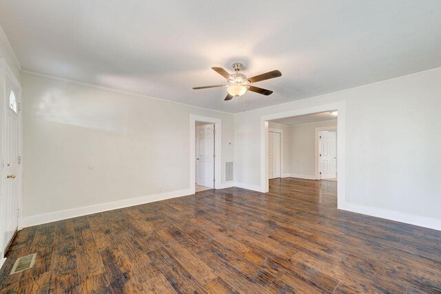 spare room with crown molding, ceiling fan, and dark hardwood / wood-style floors