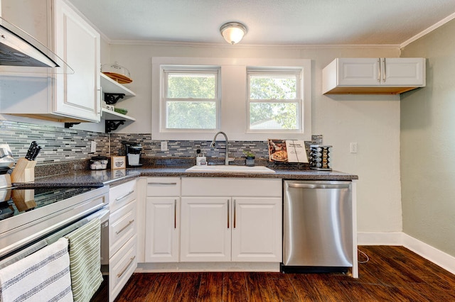 kitchen featuring white cabinetry, dark hardwood / wood-style flooring, sink, appliances with stainless steel finishes, and wall chimney range hood