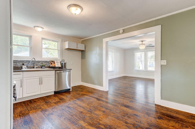 kitchen featuring white cabinets, dark hardwood / wood-style flooring, stainless steel dishwasher, and sink