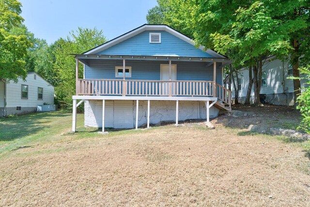 back of property featuring a yard and a deck