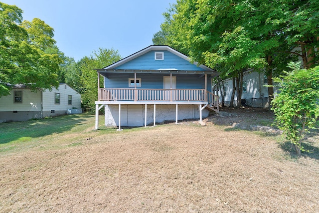 back of house featuring a deck and a lawn