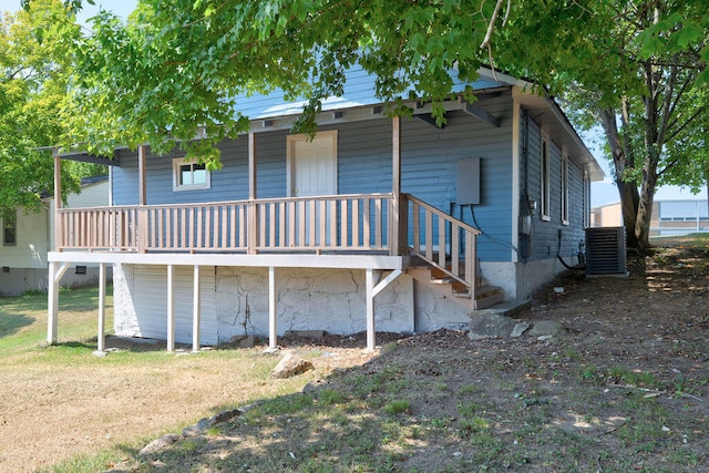 rear view of property featuring a wooden deck