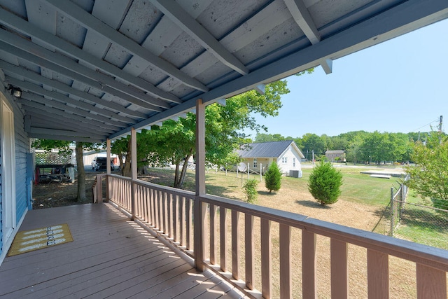 wooden terrace with a lawn